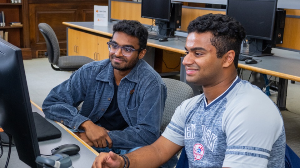 two students in classroom working together