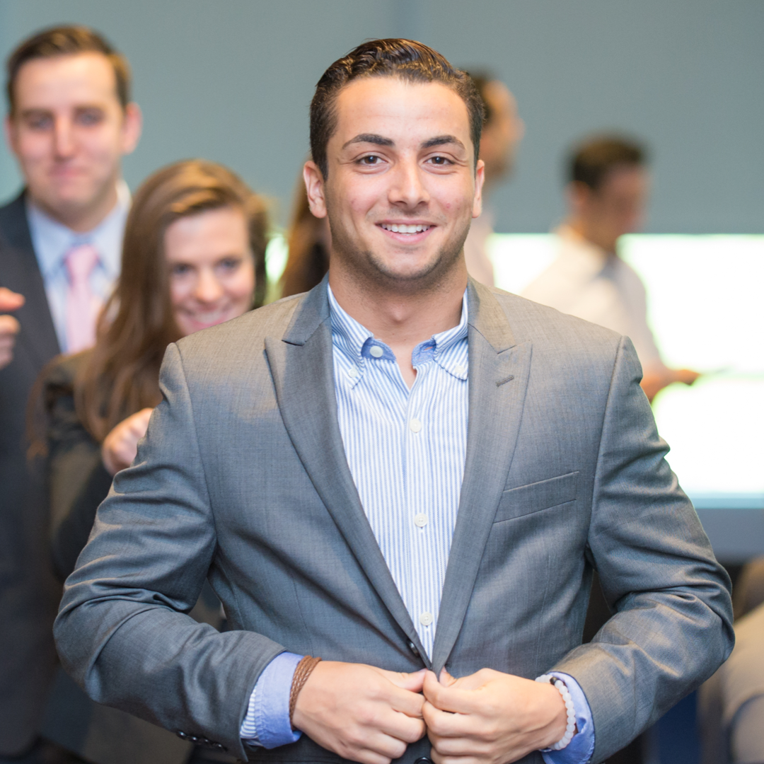 student smiling at camera in business suit