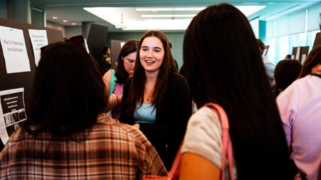 student talking to other students at career fair